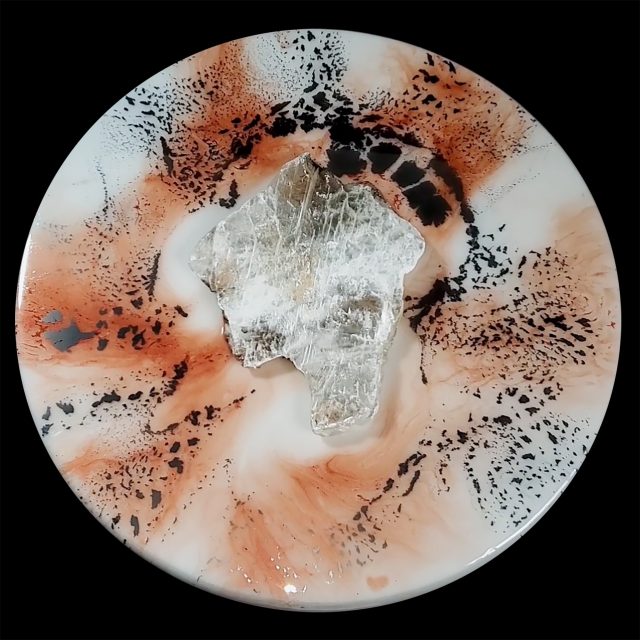 Bold selenite crystal artwork 'Elemental 141' with radiating cherry blossom metallic mica in coral tones and dramatic black mineral formations on 18-inch white circular panel by artist Aaron K Metz