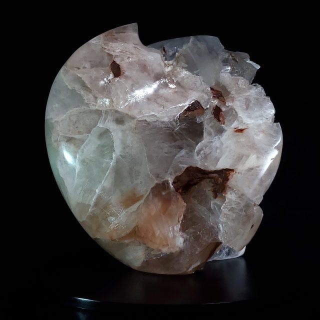 Luminous Fertility 6 selenite crystal sculpture with exceptional clarity, flowing curved form, and distinctive iron-rich earth inclusions hand-carved from rare selenite ice by artist Aaron K Metz