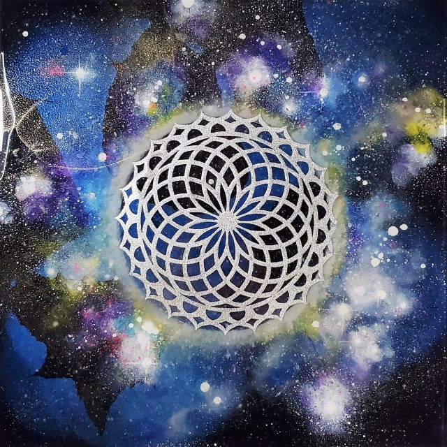 Luminous cosmic artwork 'Sacred Cosmos 15' featuring silver toroidal flower geometry suspended in a blue-green cosmic nebula with photoluminescent pigments and crystal infusions by artist Aaron K Metz