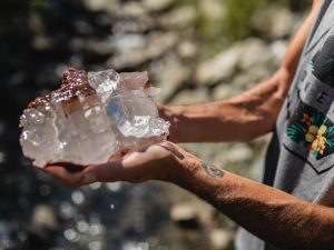 Aaron K Metz tending to selenite crystals in The Nursery creek, using natural water currents for polishing