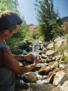 Aaron K Metz tending to selenite crystals in The Nursery creek, using natural water currents for polishing