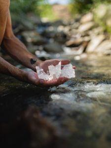 Aaron K Metz tending to selenite crystals in The Nursery creek, using natural water currents for polishing