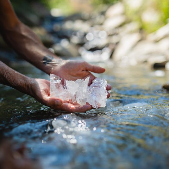 Aaron K Metz tending to selenite crystals in The Nursery creek, using natural water currents for polishing