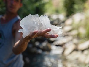 Aaron K Metz tending to selenite crystals in The Nursery creek, using natural water currents for polishing