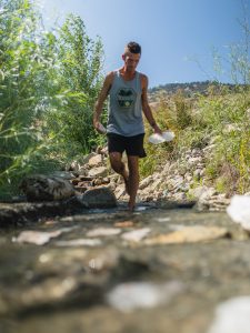 Aaron K Metz tending to selenite crystals in The Nursery creek, using natural water currents for polishing