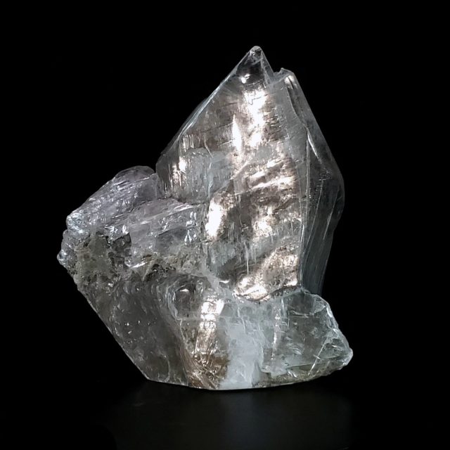 Dynamic selenite crystal sculpture with dramatic crystalline peaks featuring rare ancient blue-green algae inclusions suspended within transparent selenite ice, hand-carved from Utah selenite by Aaron K Metz