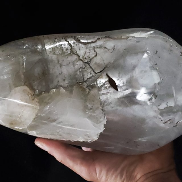 Distinctive vessel-like selenite crystal sculpture with subtle red earth inclusions and graceful curves hand-carved from translucent selenite ice by Aaron K Metz