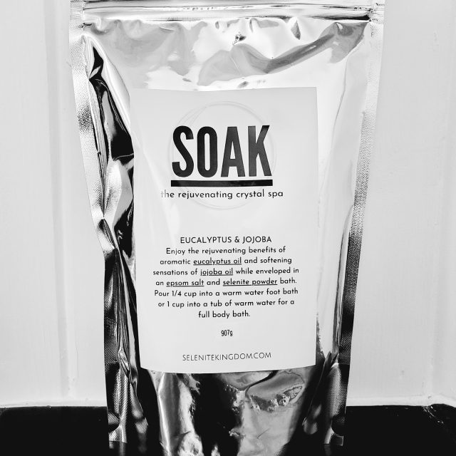 Silver pouch of SOAK selenite crystal bath salts with eucalyptus and jojoba